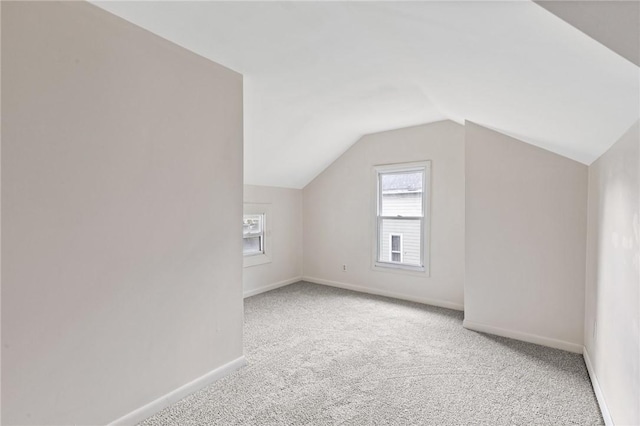 bonus room featuring light colored carpet and vaulted ceiling