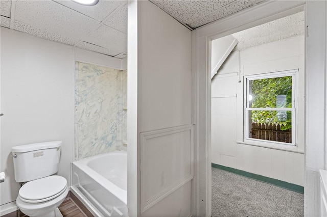 bathroom featuring hardwood / wood-style floors, toilet, and a drop ceiling