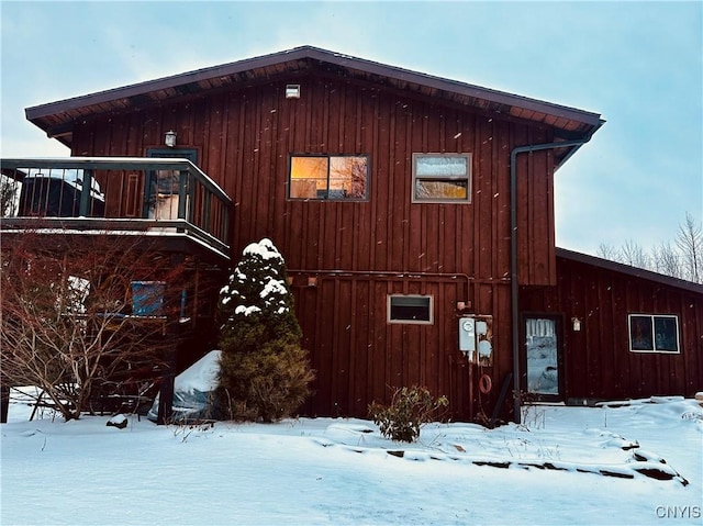 view of snowy exterior with a balcony