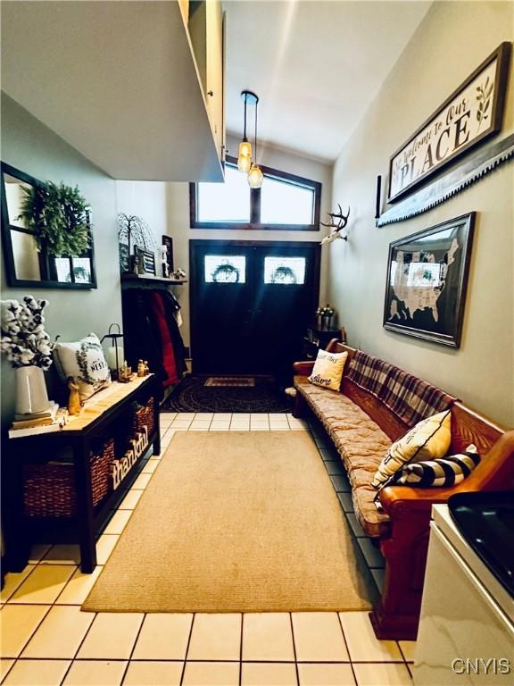 tiled foyer featuring lofted ceiling