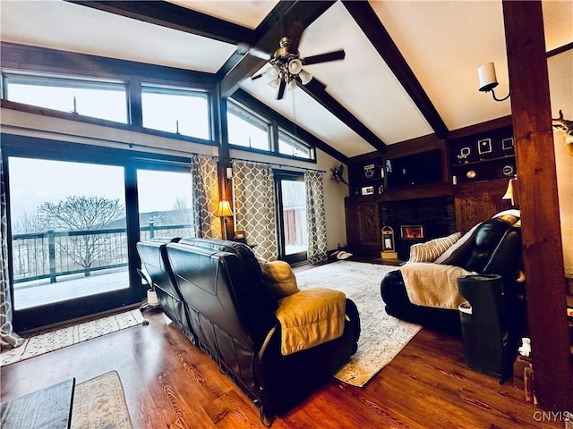 living room featuring vaulted ceiling with beams, ceiling fan, plenty of natural light, and dark wood-type flooring