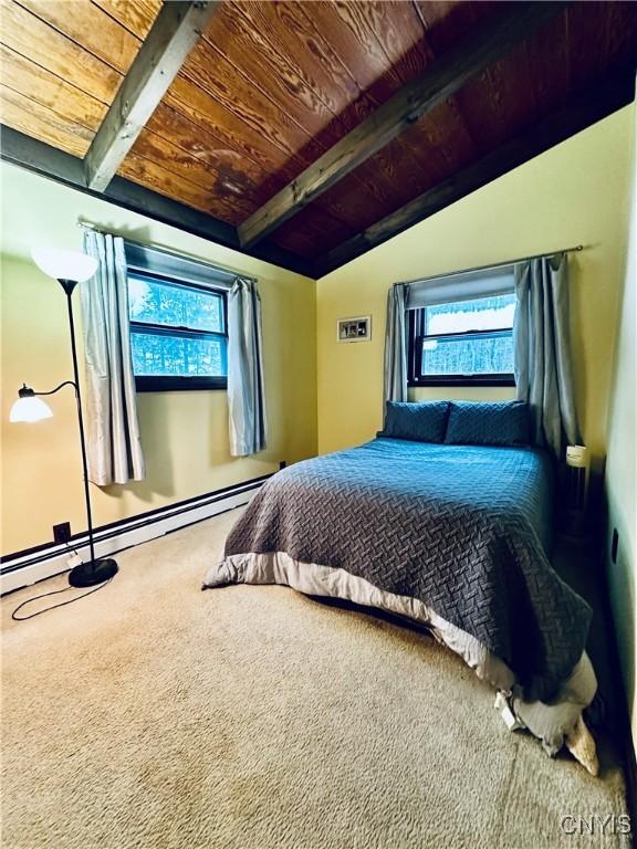 bedroom with carpet, a baseboard heating unit, vaulted ceiling with beams, and wooden ceiling