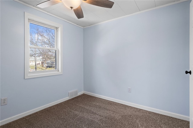 spare room featuring carpet flooring, a wealth of natural light, ceiling fan, and crown molding