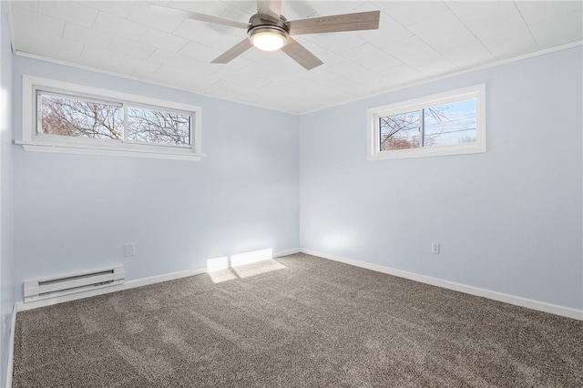 carpeted empty room featuring baseboard heating, ornamental molding, and ceiling fan