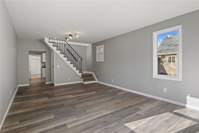 unfurnished living room with dark hardwood / wood-style flooring