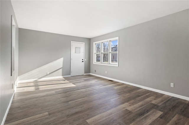 spare room with dark hardwood / wood-style floors