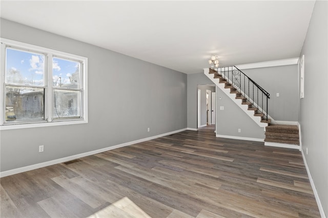 unfurnished living room with dark wood-type flooring