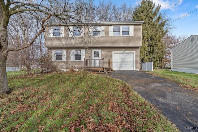 view of front of property featuring a garage and a front lawn