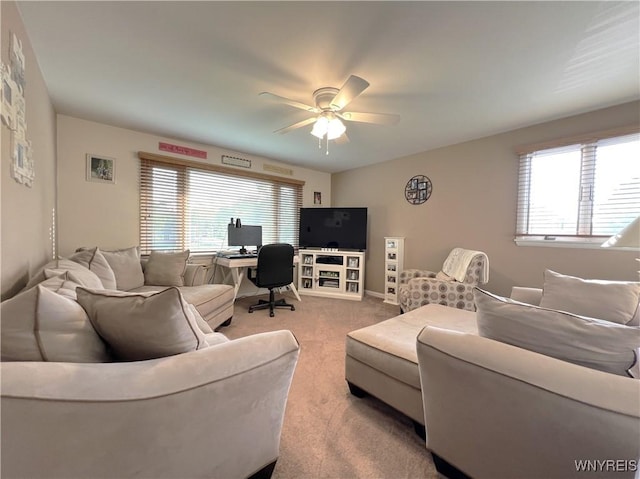 carpeted living room with ceiling fan