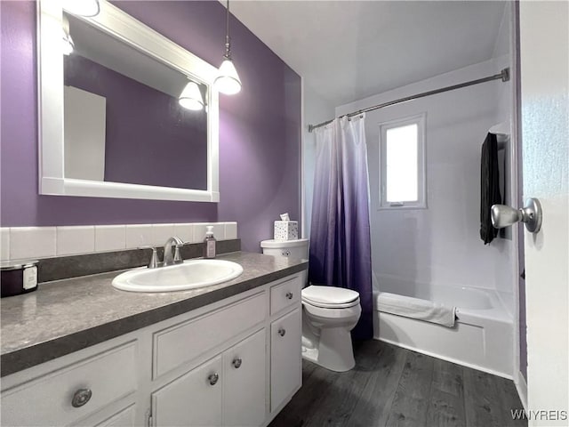 full bathroom featuring hardwood / wood-style floors, vanity, toilet, and shower / bathtub combination with curtain