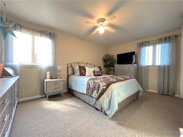 bedroom with light colored carpet and ceiling fan