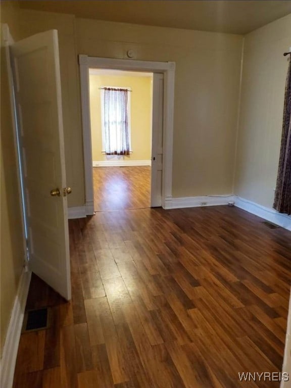 spare room with dark hardwood / wood-style floors