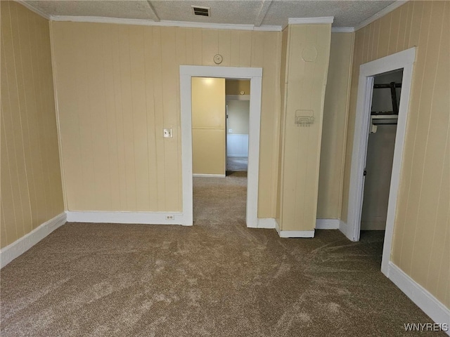 empty room featuring carpet and crown molding