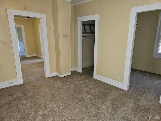 unfurnished bedroom with a closet and dark colored carpet