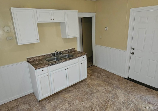 kitchen featuring sink and white cabinetry