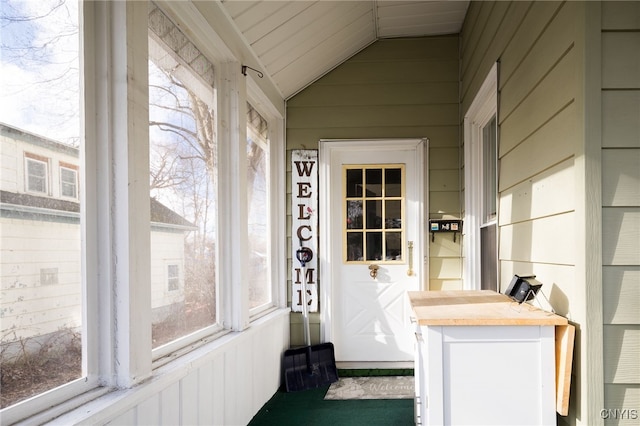 sunroom / solarium featuring a wealth of natural light and vaulted ceiling