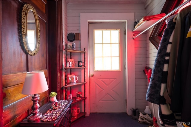 entryway featuring wooden walls