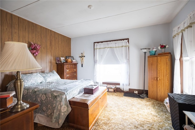 bedroom featuring carpet and wooden walls