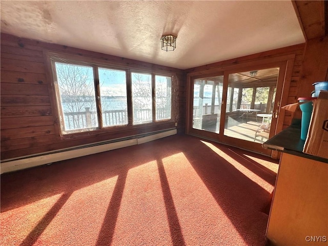 unfurnished sunroom with a baseboard radiator