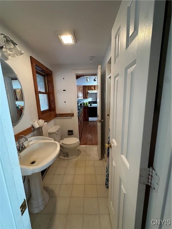 bathroom featuring tile patterned floors, sink, and toilet