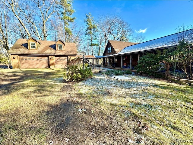 view of yard with a porch and a garage