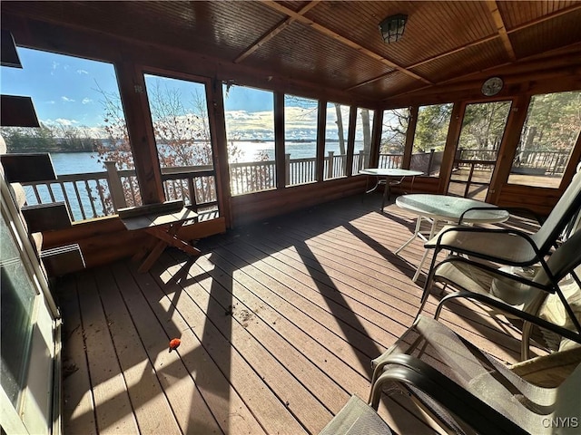 sunroom featuring plenty of natural light, a water view, wood ceiling, and vaulted ceiling