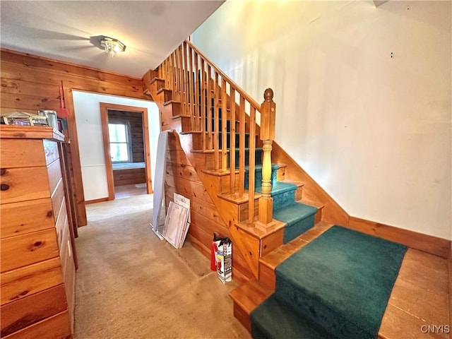 stairs with wooden walls and carpet