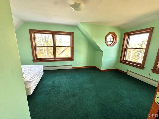 bonus room with dark colored carpet, vaulted ceiling, and a baseboard heating unit