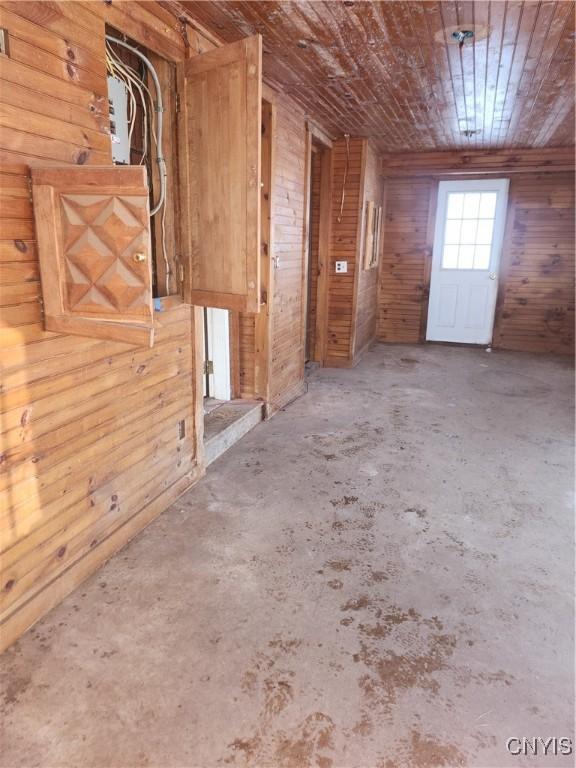 4057 Wilson Rd E, Annsville, NY 13471 - empty room with concrete floors, wood walls, and wooden ceiling