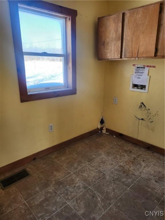 washroom with cabinets and hookup for a washing machine