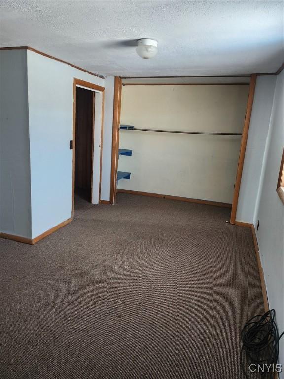 4057 Wilson Rd E, Annsville, NY 13471 - carpeted empty room with baseboards and a textured ceiling
