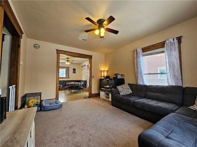 living room with light colored carpet and ceiling fan