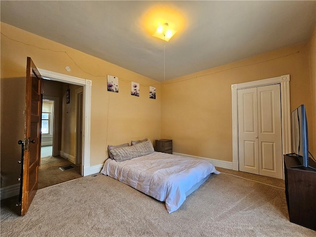 carpeted bedroom featuring a closet