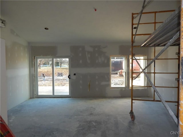 spare room with a wealth of natural light and concrete floors