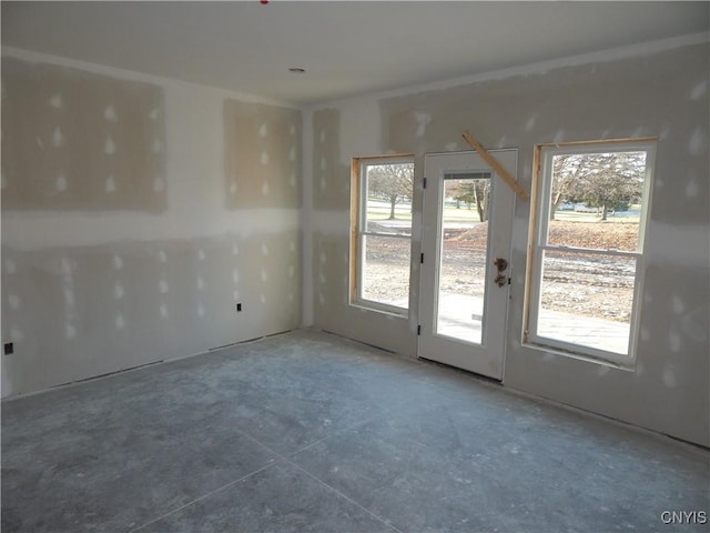 unfurnished room featuring concrete floors