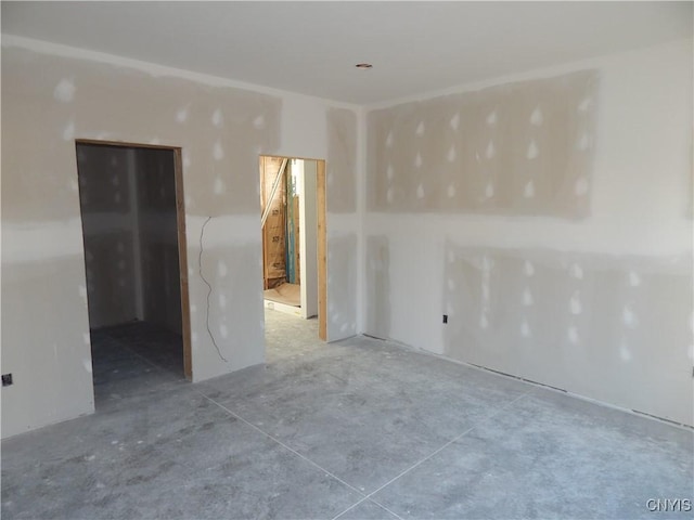 spare room featuring concrete flooring