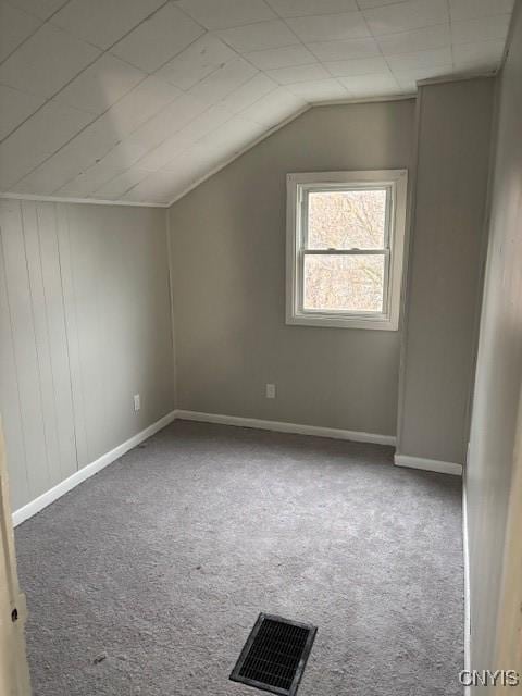 bonus room with carpet floors and vaulted ceiling