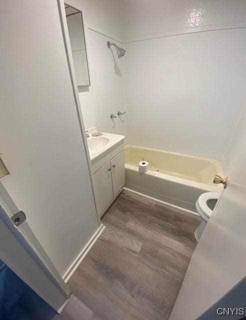 full bathroom with shower / tub combination, vanity, wood-type flooring, and toilet