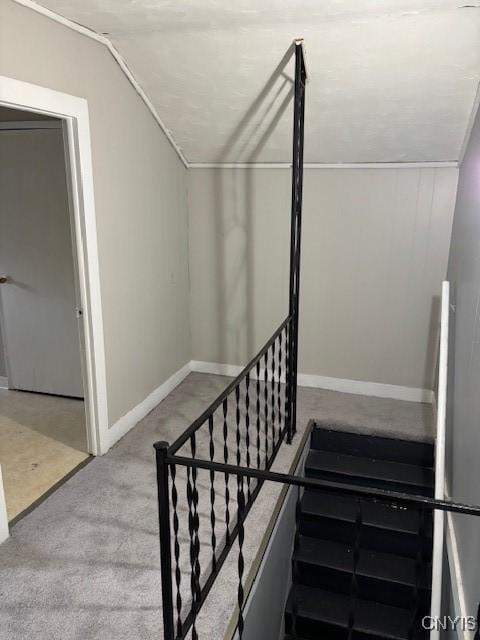 staircase with carpet and lofted ceiling