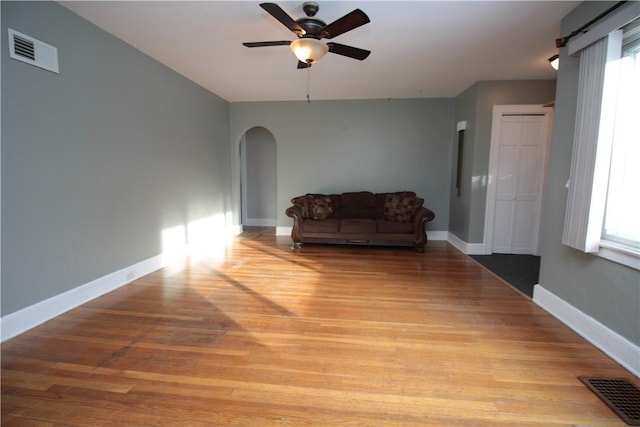 living area with light wood-type flooring, plenty of natural light, and ceiling fan