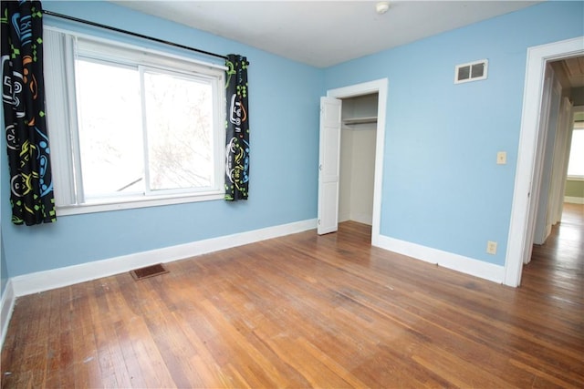 unfurnished bedroom featuring hardwood / wood-style flooring