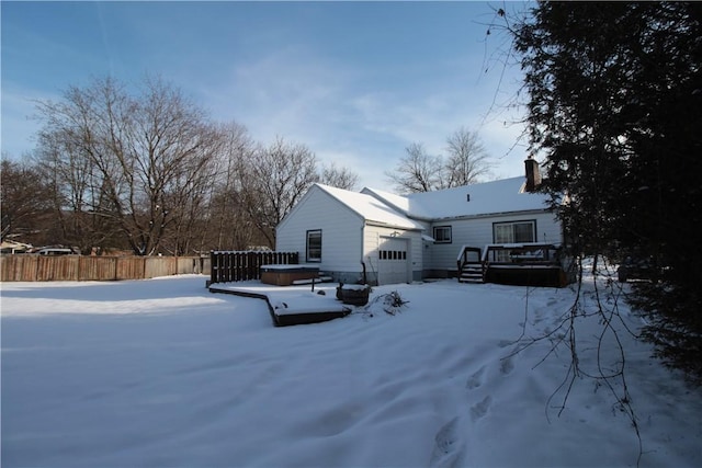 yard covered in snow featuring a hot tub and a deck