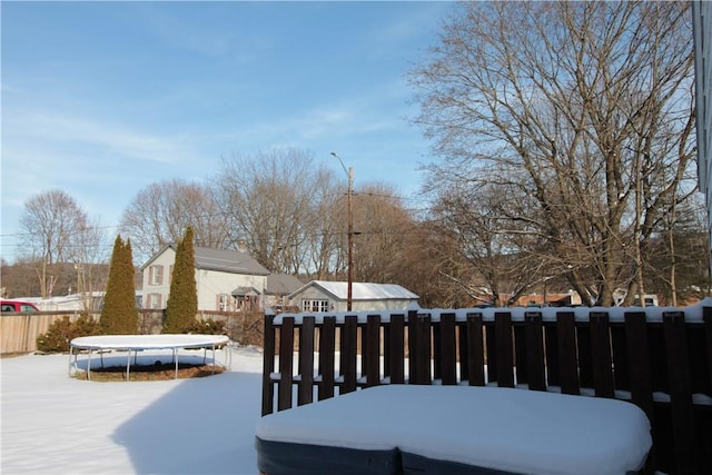 snow covered deck with a trampoline