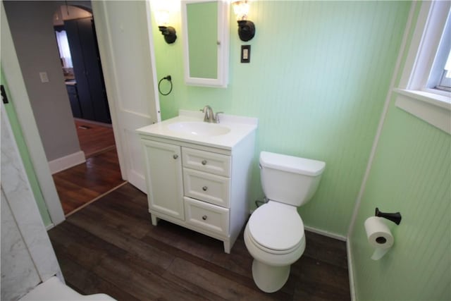 bathroom featuring vanity, wood-type flooring, and toilet