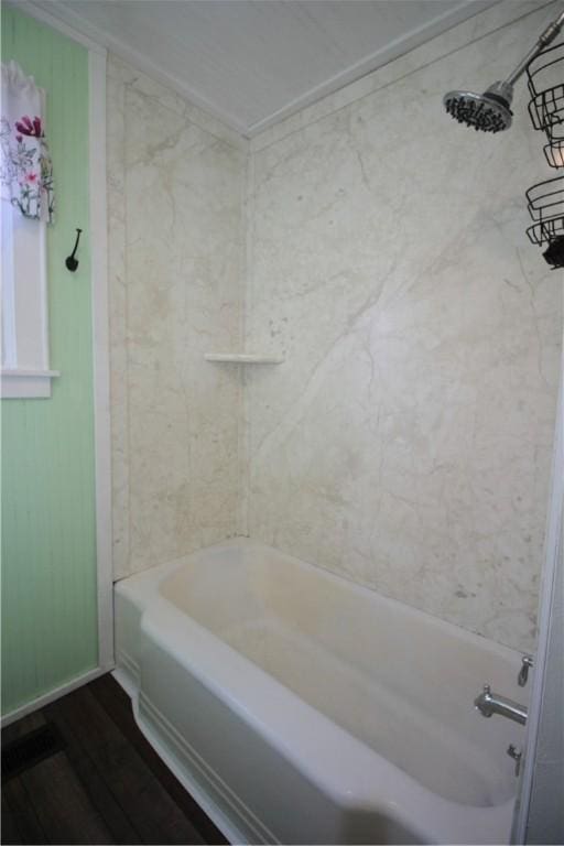 bathroom featuring hardwood / wood-style floors and  shower combination