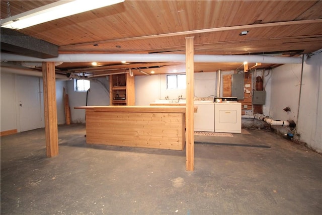 basement featuring electric panel and washer and dryer