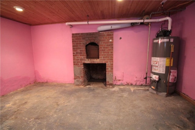 unfurnished living room with a fireplace, gas water heater, and concrete flooring