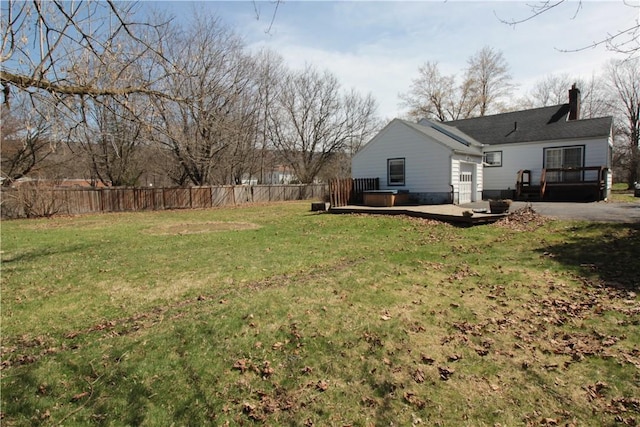 view of yard featuring fence and a wooden deck