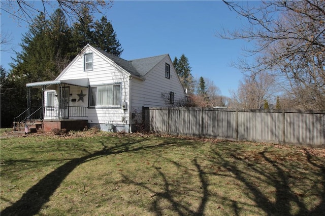 exterior space featuring a front yard and fence