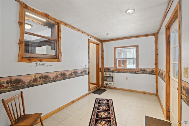 interior space featuring a textured ceiling and heating unit